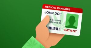 a hand holding a medical marijuana card